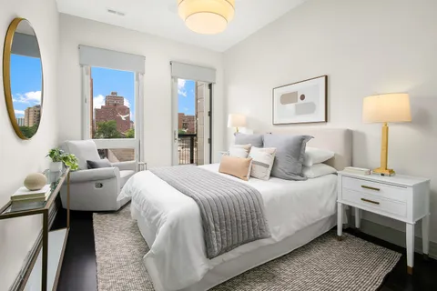 a bathroom with a granite countertop sink toilet and mirror