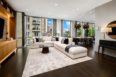 a dining room with furniture window and wooden floor