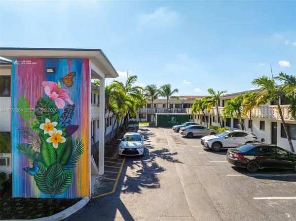 a view of a parking space with potted plants