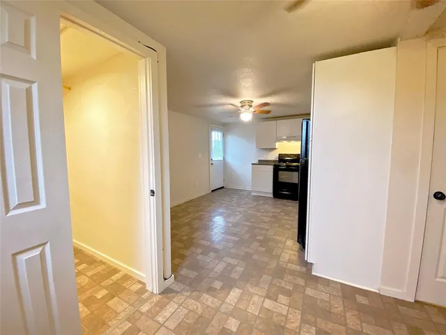 a view of a room with a refrigerator