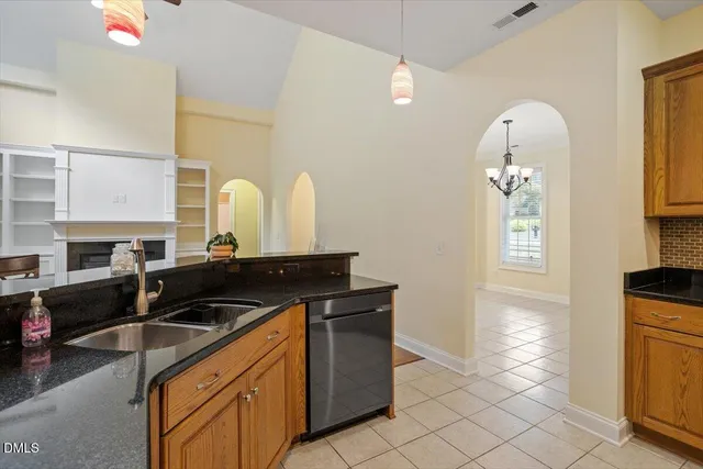 a kitchen with granite countertop a stove and a microwave