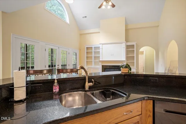 a view of empty room with wooden floor and fireplace