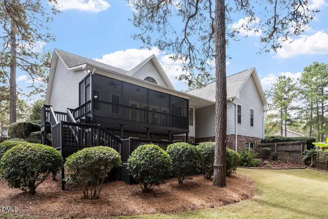 a view of a house with tub and trees in the background