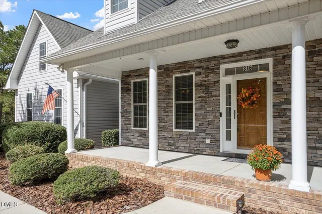 a view of a brick house with plants