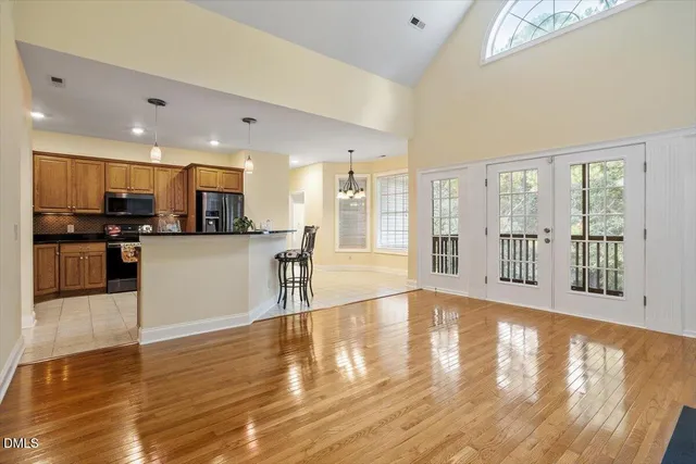 a view of kitchen with granite countertop window and refrigerator