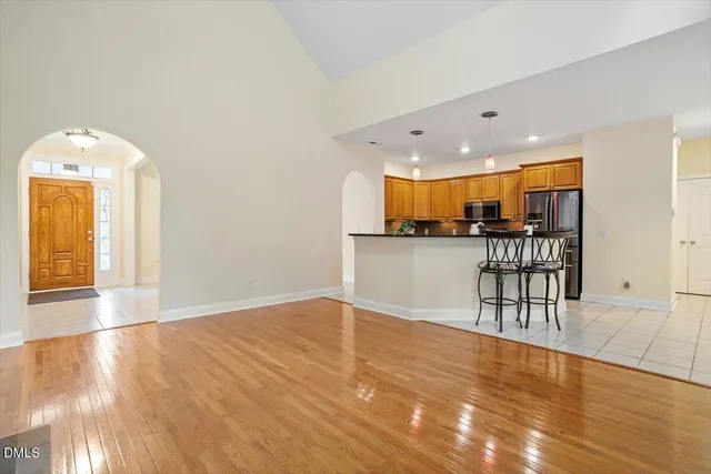 a kitchen with stainless steel appliances granite countertop a sink a stove and a refrigerator