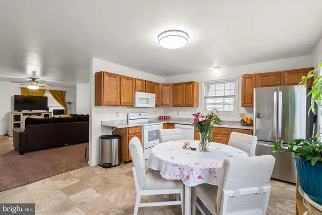 a kitchen with a refrigerator and a stove top oven