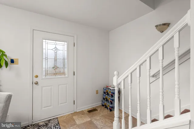 a view of an entryway with wooden floor
