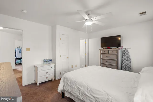 a bedroom with a bed and a television