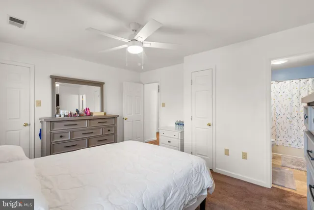 a bedroom with a bed and a dresser