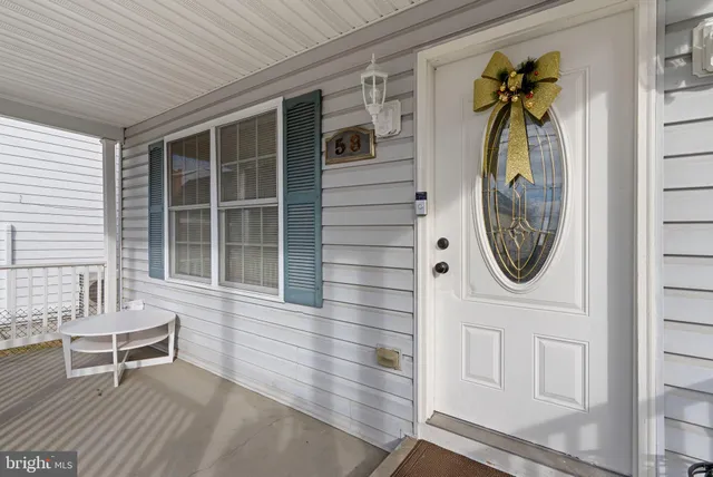 a front view of a house with outdoor seating