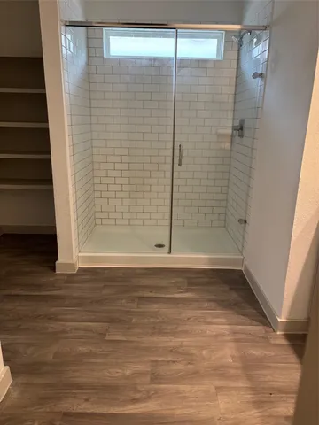 an empty room with a chair and a window