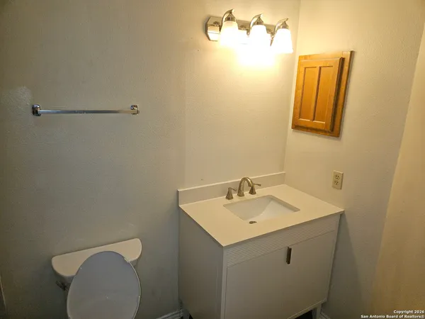 a bathroom with a sink mirror and vanity