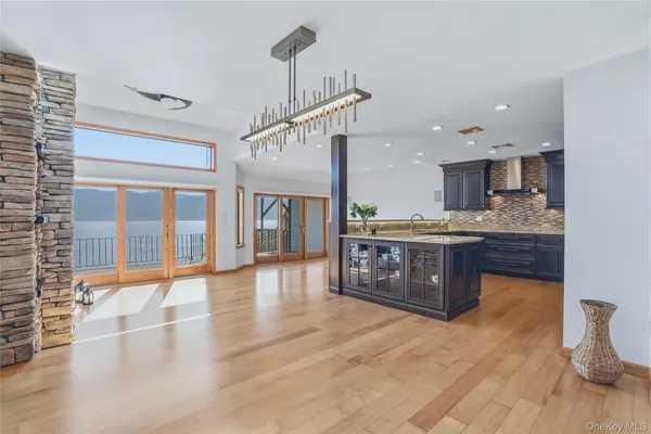 a open kitchen with stainless steel appliances granite countertop a sink refrigerator and cabinets
