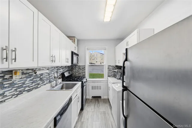 a kitchen with a sink appliances and cabinets