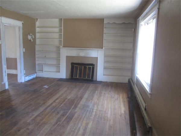 104 Fenwick Street Springfield, MA 01109 - Photo 4 of 12 wooden floor fireplace and windows in an empty room
