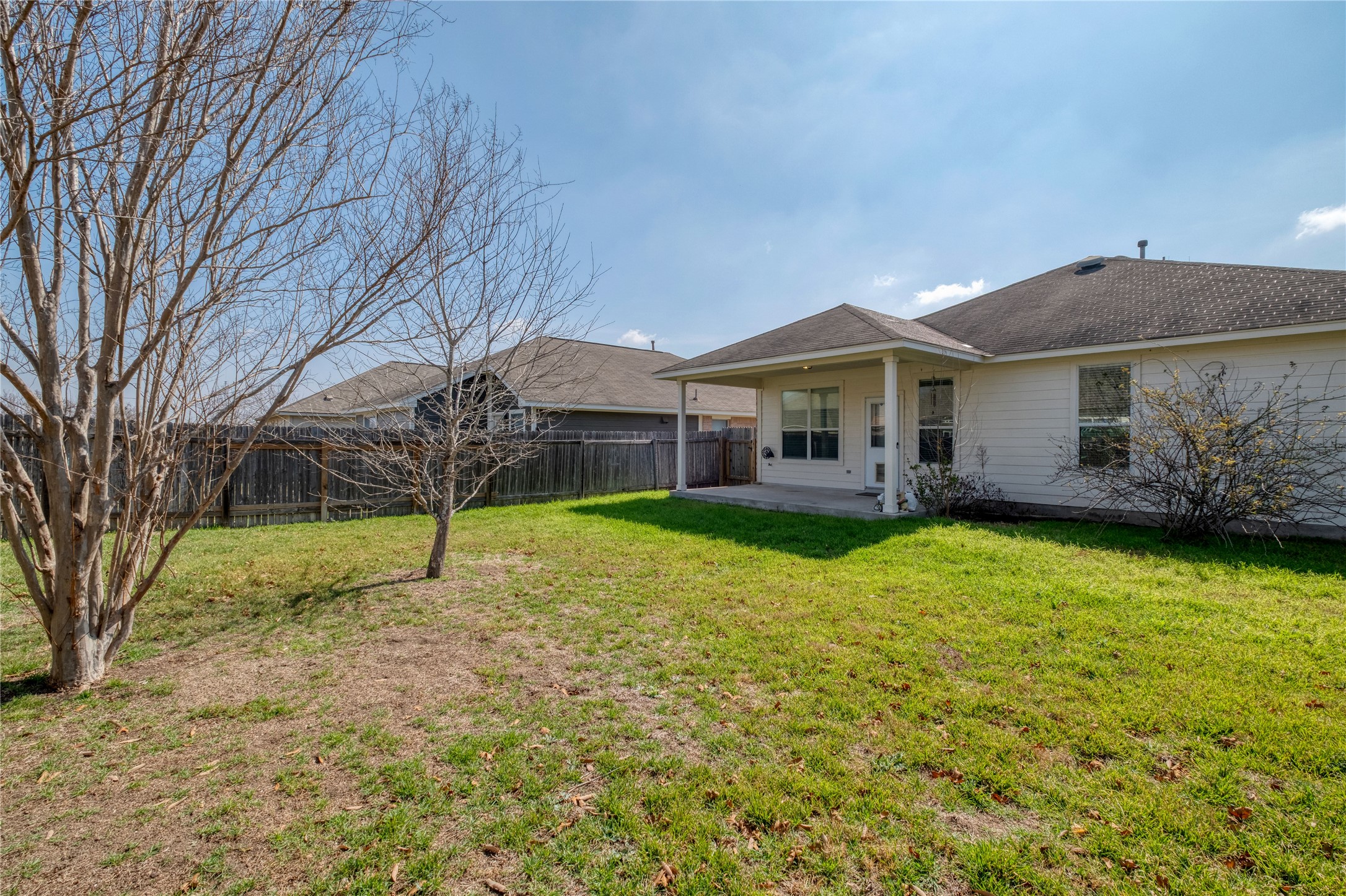 194 Cold Springs Spring Buda, TX 78610 - Photo 17 of 17 Rear view of property featuring a patio area, a fenced backyard, and a shingled roof