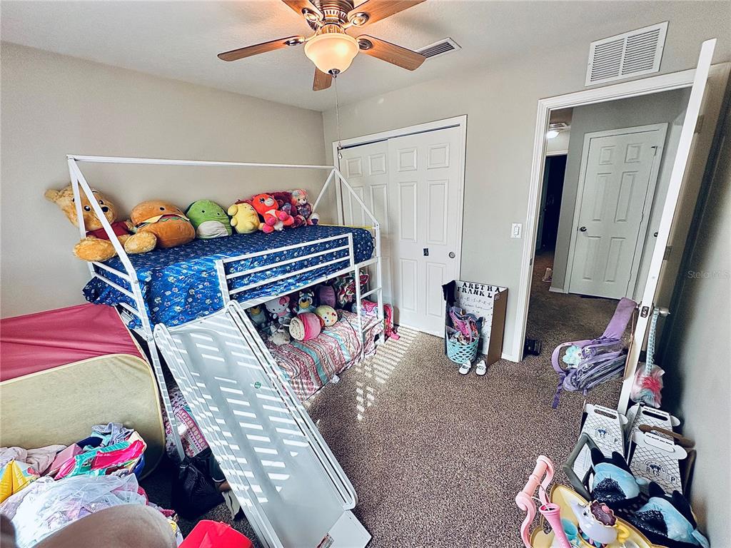 4411 Banyan Tree Place Riverview, FL 33578 - Photo 21 of 27 a bedroom with a bed and cabinets