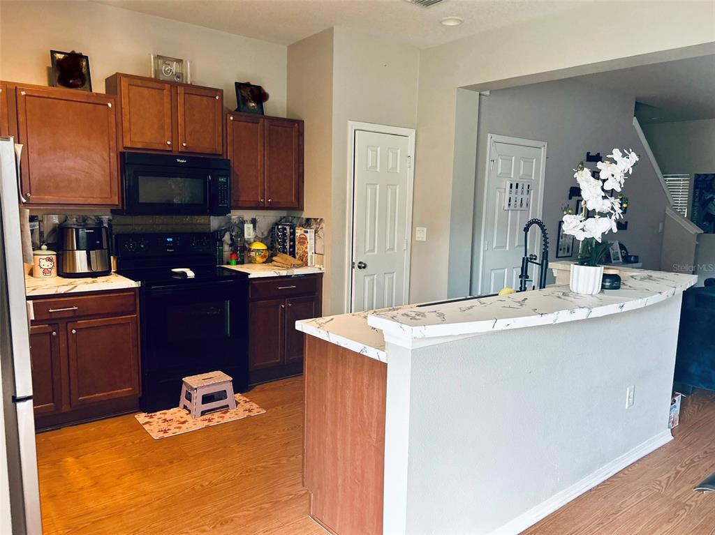 4411 Banyan Tree Place Riverview, FL 33578 - Photo 9 of 27 a kitchen with a sink stove and refrigerator