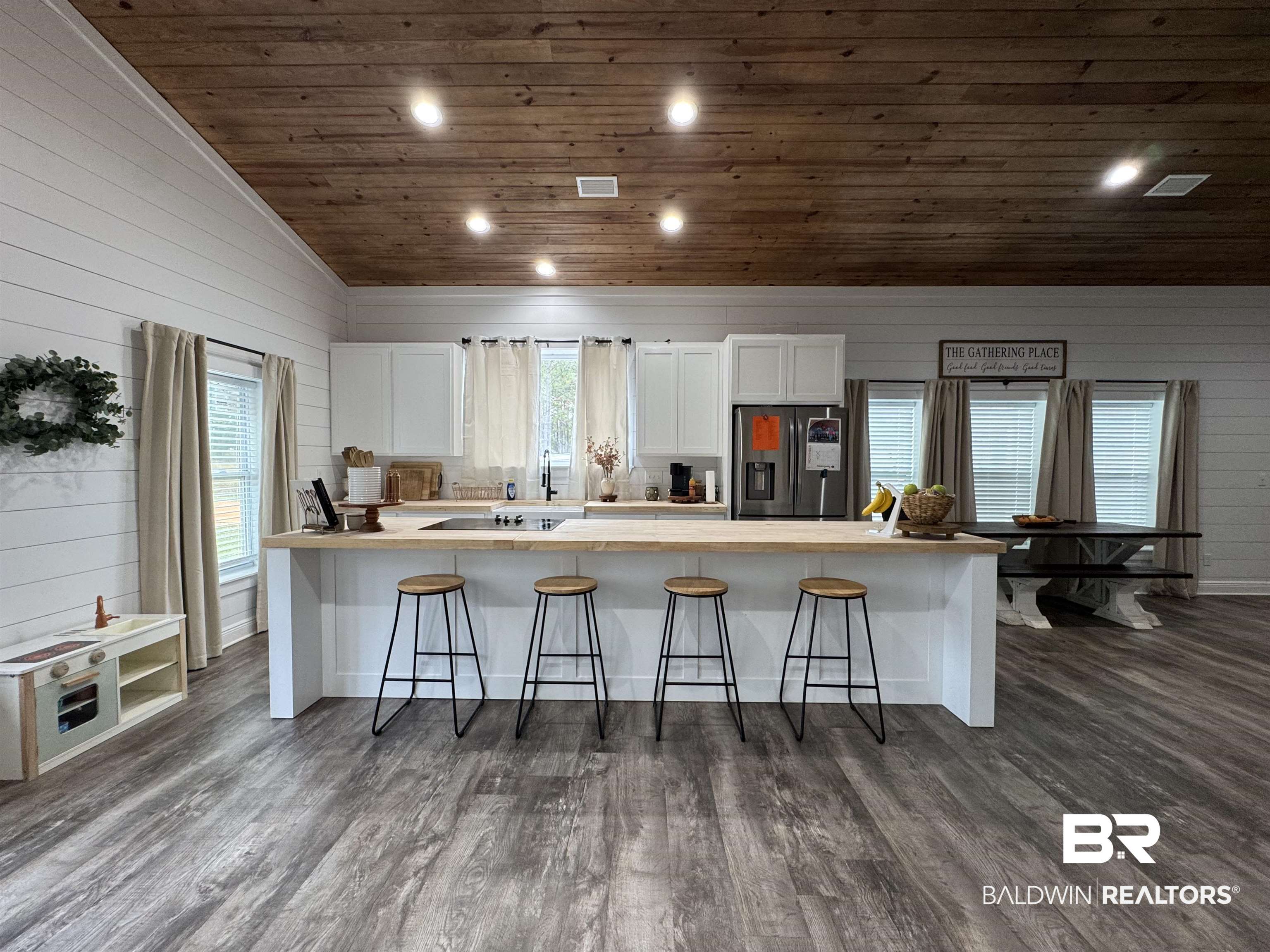 370 Dianne Road Frisco City, AL 36445 - Photo 7 of 41 Kitchen with dark wood-type flooring, stainless steel refrigerator with ice dispenser, vaulted ceiling, and white cabinets
