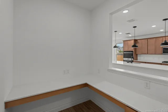 a view of kitchen with wooden floor and electronic appliances