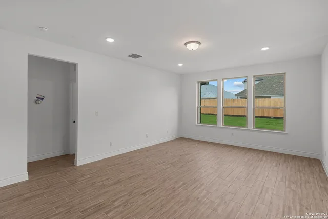 wooden floor in an empty room with a window