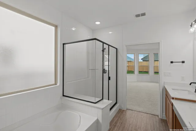 a bathroom with a shower and a tub