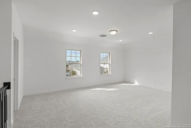 an empty room with windows and closet