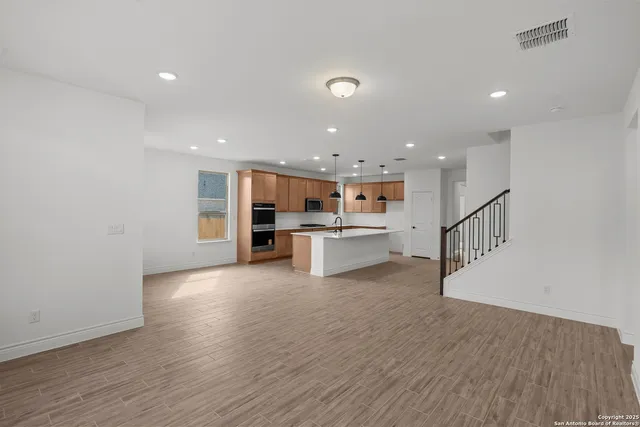 a view of kitchen with wooden floor and electronic appliances
