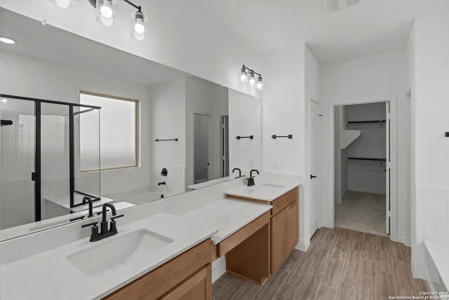 a bathroom with a sink double vanity and a mirror