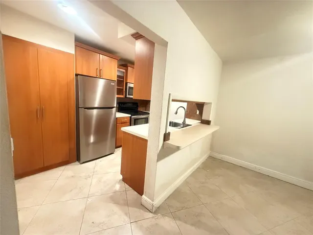 a kitchen with stainless steel appliances a refrigerator and a stove