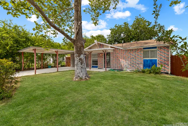 a front view of house with yard and green space