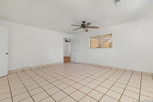 a bathroom with a granite countertop toilet sink and mirror