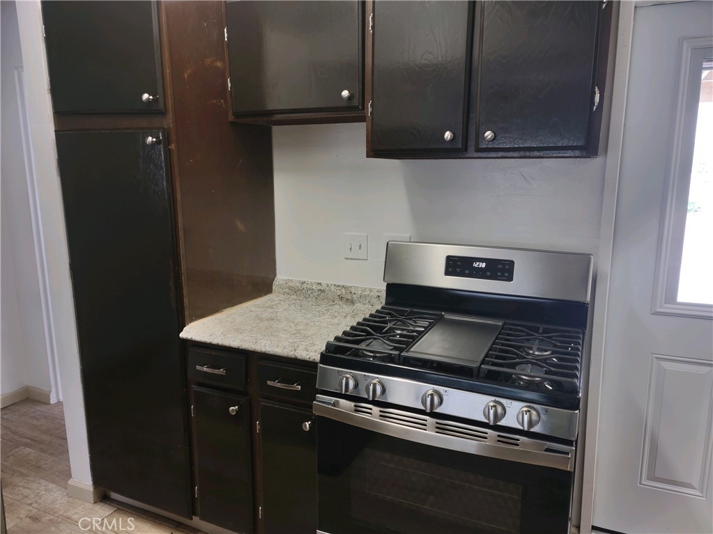611 Los Osos Valley Road Los Osos, CA 93402 - Photo 4 of 13 a kitchen with wooden cabinets and a stove top oven
