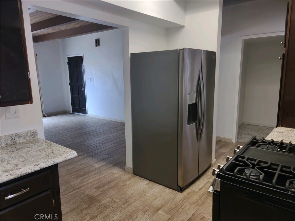 611 Los Osos Valley Road Los Osos, CA 93402 - Photo 5 of 13 a kitchen with granite countertop a refrigerator and a stove