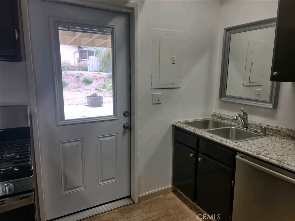 611 Los Osos Valley Road Los Osos, CA 93402 - Photo 6 of 13 a bathroom with a granite countertop sink a mirror and a window