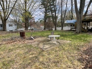 41 Elizabeth Road Billerica, MA 01821 - Photo 17 of 18 a white bench sitting in a yard with large trees