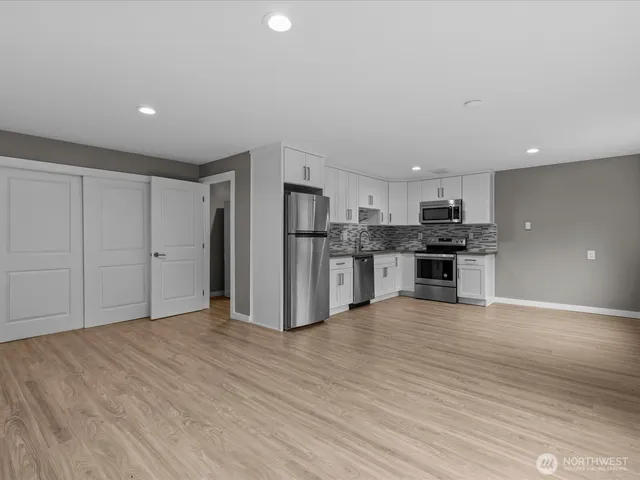a view of kitchen with stainless steel appliances refrigerator and microwave