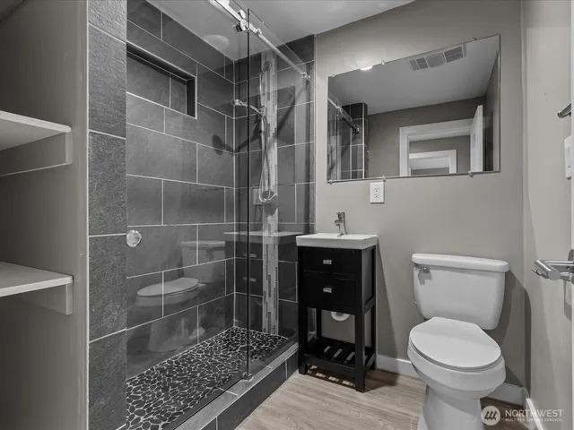 a bathroom with a toilet and a shower