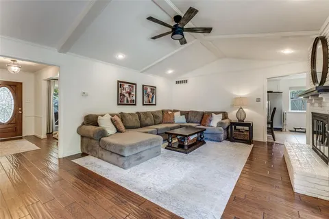 a living room with furniture a ceiling fan and a rug