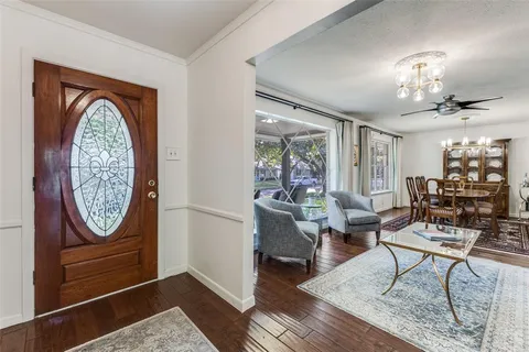 a living room with furniture a chandelier and a window