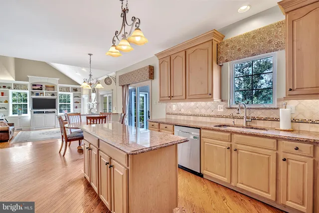 a kitchen with stainless steel appliances granite countertop a sink refrigerator stove and microwave