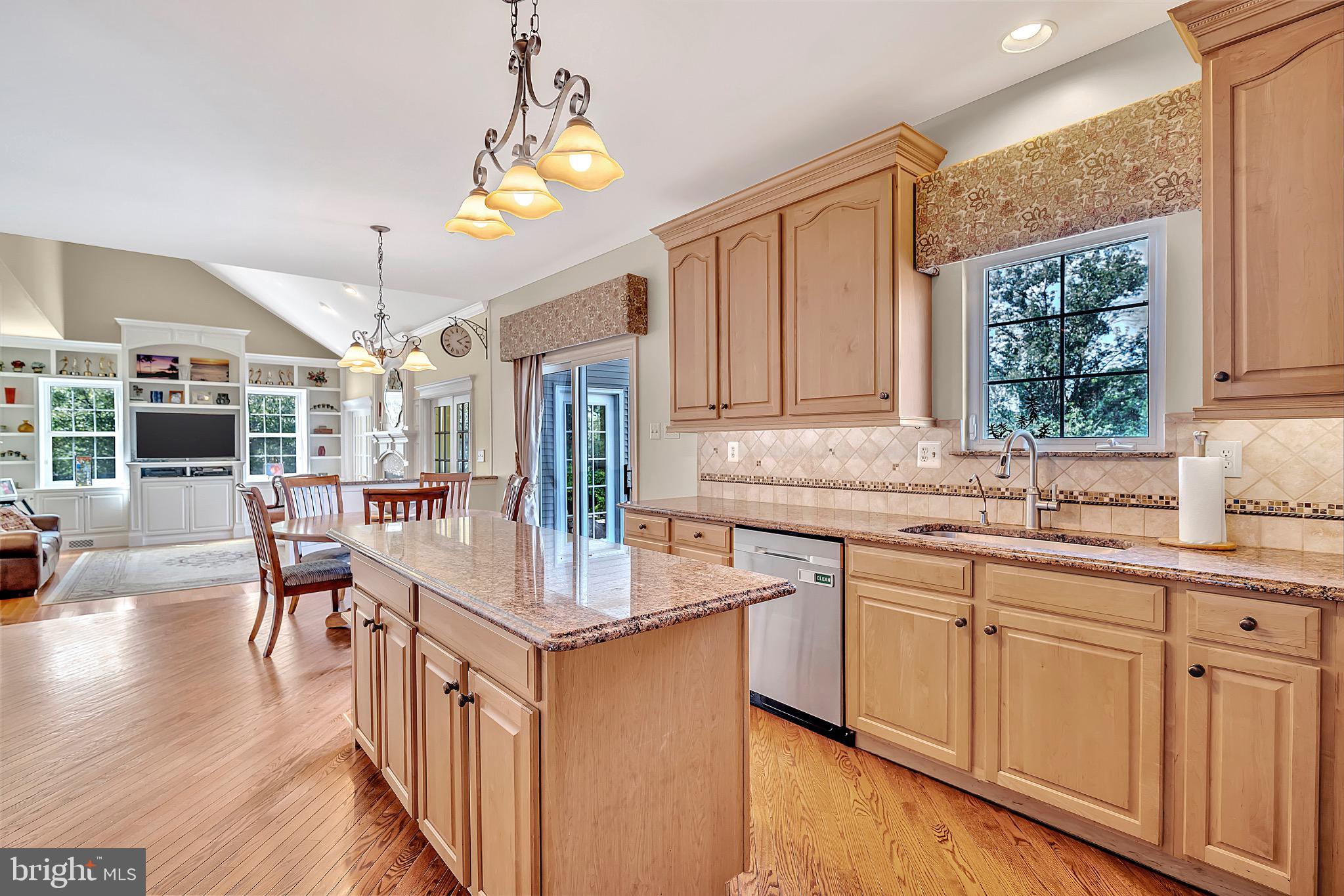 7 Anderson Lane Robbinsville, NJ 08691 - Photo 21 of 54 a open kitchen with stainless steel appliances granite countertop a sink dishwasher a stove and a dining table with wooden floor