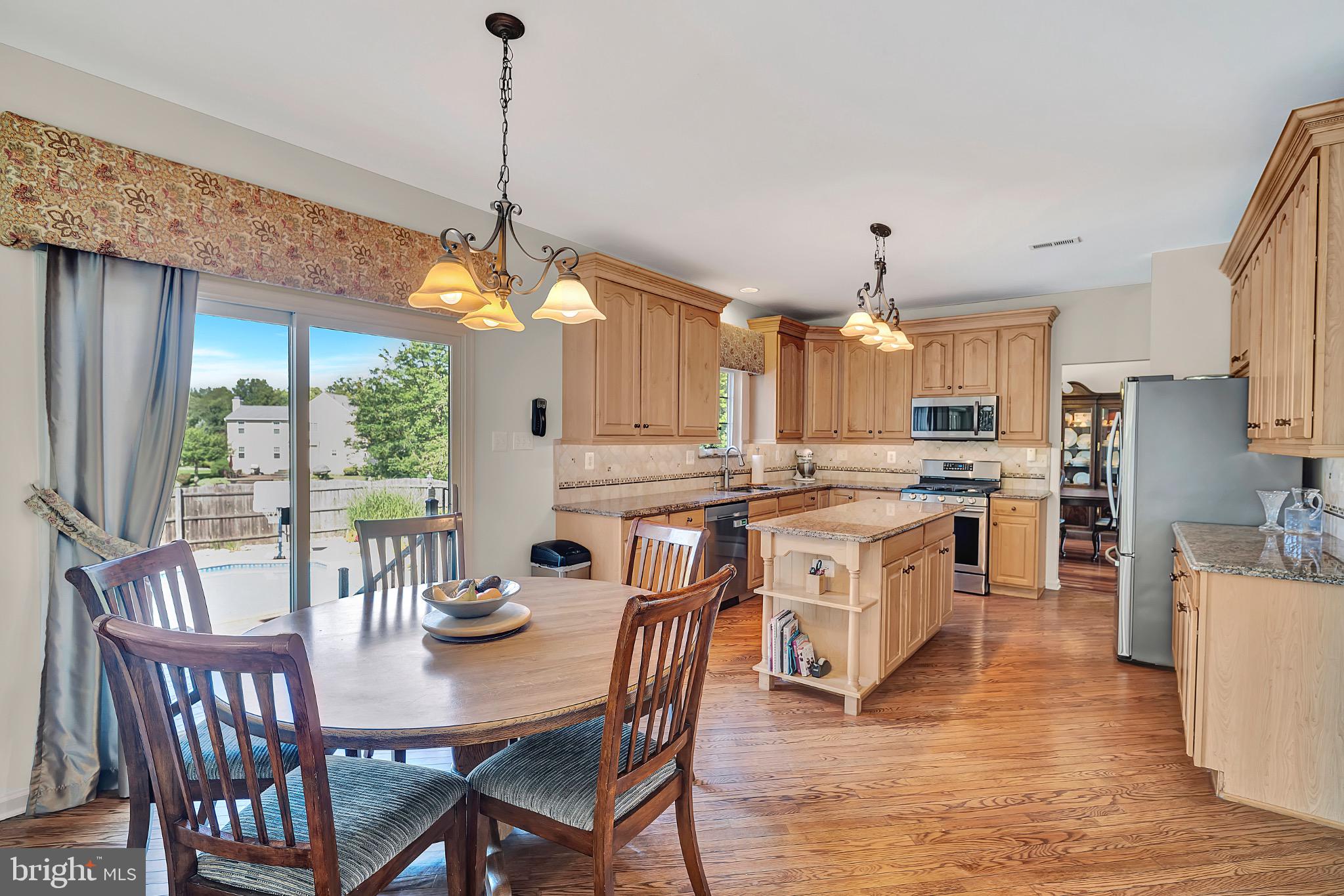 7 Anderson Lane Robbinsville, NJ 08691 - Photo 24 of 54 a kitchen with stainless steel appliances granite countertop a stove a kitchen island a table and chairs
