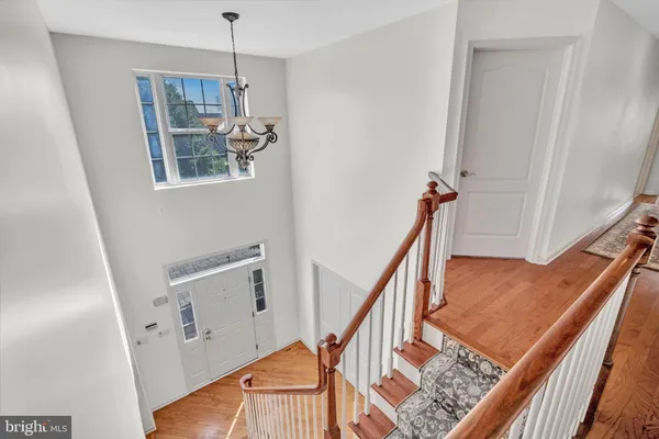 a spacious bedroom with a large bed a couch and two large window