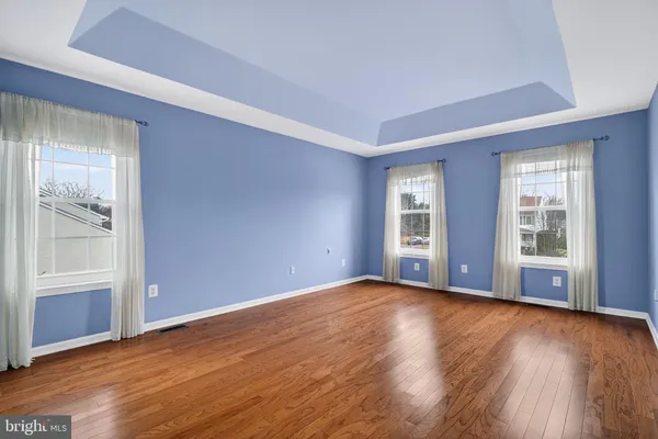 a spacious bedroom with a large bed couch and a window