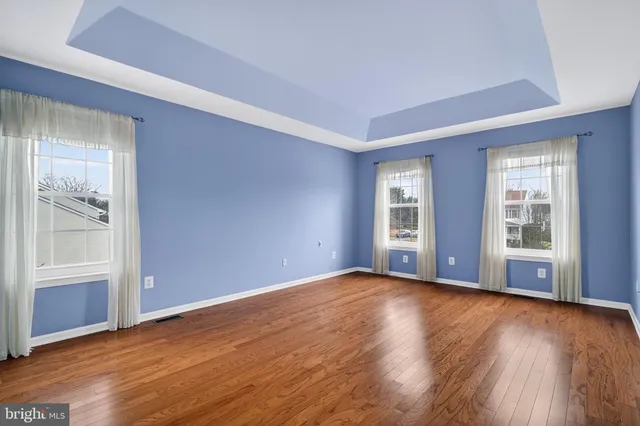 a spacious bedroom with a large bed couch and a window