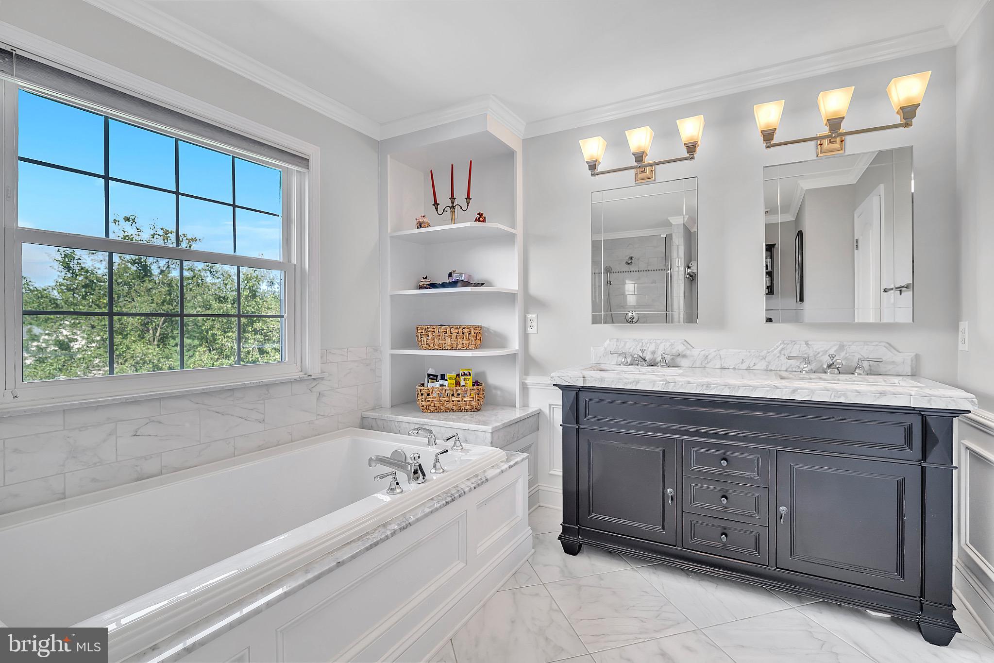 7 Anderson Lane Robbinsville, NJ 08691 - Photo 32 of 54 a bathroom with a tub a double vanity sink and a large mirror