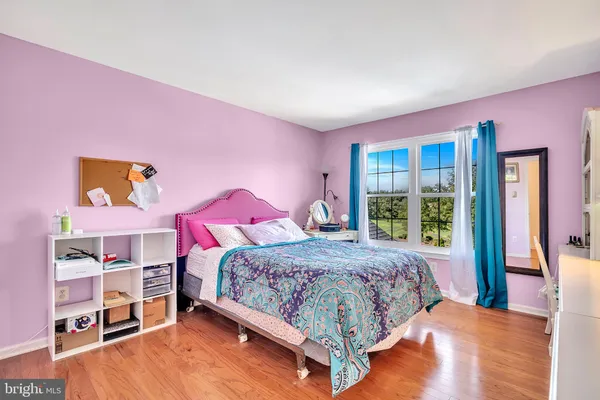 a bathroom with a granite countertop sink mirror and toilet