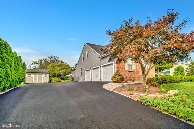 a view of a house with a big yard and potted plants